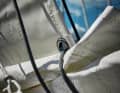 The hoisting point of the reefing line must be aft enough to pull the sail flat