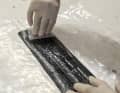 The special adhesive is spread evenly over the sail and the patch using a flexible spatula. The patch is cut out of special 3DI repair material. Important: round off the corners, otherwise they will quickly peel off again