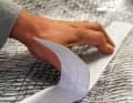 Determine the length, degrease and desalinate the surface (at least wipe it with fresh water) and round off the corners of the number cloth. Additional spray adhesive can also help here, then stick it on. Press down firmly on a flat surface