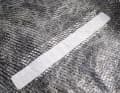 Turn the sail over and glue the tear from the back in the same way. The procedure is the same: determine the size, degrease and desalinate, round off the corners and so on. A cutting board, a companionway bulkhead or a scaffolding door can be used as a base
