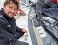 Boris Herrmann repairs a jib.  There are no spare sails on board. The total loss of a complete canvas would tear a serious hole in the finely graded wardrobe.