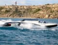 Gliding instead of flying. Although the boat has a central foil, it rests on the water at the front and sides while travelling.