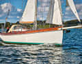 The steep stern and the pronounced deck step are characteristic of the successful self-build.
