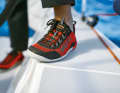 Ideally, you should wear non-slip sailing shoes. Sports shoes with white soles will also do. Only soles that rub off are taboo.