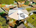 Aesthetics meets purpose on Maui: a wheel construction made from local bamboo and a disused sail provides shade and allows cooler air to flow through.