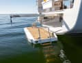 The bathing platform extends to the waterline, the ladder is folded out to the side.