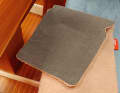 The woollen texture is part of the cover, the actual heating element can be removed for washing