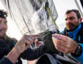 Charlie Enright and Jack Bouttell bolt a carbon fibre plate to the luff of the mainsail