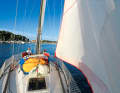 Two massive spars flank the foredeck.  The wide overlapping genoa is typical of the IOR era