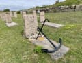 The grave is decorated with an anchor, the only distinguishing feature.