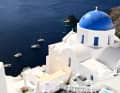 White buildings, blue roofs, picture-book Greece.
