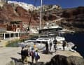 Day guests board an excursion catamaran.