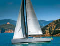 Mediterranean dreams. The Vismara V50 "Dragon" in front of the Scoglio dello Sparviero near Punta Ala: elegant ship on azure waters