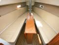 Saloon: Open-plan layout with sunbathing area in the bow and hull windows. The retractable keel sits in the saloon table