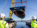 The Frers design is already floating above the water.
