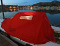 Blue hour under a red dome tent. If required, the Lite XP offers dry seating in the cockpit and a double berth in the foredeck.