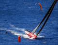 All in red: The crew of "I Love Poland" and a foil kiter in double action