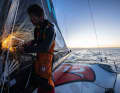 Until the sparks fly: Jack Bouttell cuts off the protruding bolt ends on the repaired mainsail