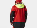 The hood with visor against spray and storms. It can be stowed in the collar
