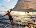 Freedom on the ocean: Tim Hund on the boom of the "Arrya" sailing into the sunset