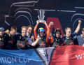 CEO, skipper and helmsman Ben Ainslie with the Louis Vuitton Cup and his loyal crew