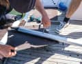 Drilled & tensioned: The hose clamp tape is cut to size, pulled through the drilled holes in the floor board and then tightened to the highest possible tension using a screwdriver