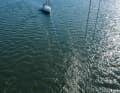 The longer the line, the smoother the furling. The foam crown aft is caused by the drift anchor