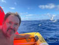 Sad certainty: the stricken Martin Daldrup in the life raft, his sinking yacht in the background