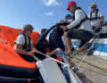 ... and escorted into the life raft