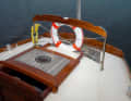 The teak-covered and mahogany-framed sliding hatch leads into the small aft cabin, which a family crew will use for the children