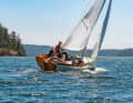 The small boat is characterised by a positive natural wood stern, the clear lacquered coaming and strong lines