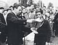 The Danish top sailor Paul Elvstrøm presents one of the first Opti sailors in Europe with the regatta prize in 1959