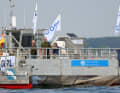 The "SeeKuh I", built in Lübeck, collects seaweed that has been pulled loose from the surface of the water in the Bay of Strande during Kiel Week