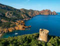 Anchorage amidst the rocky backdrop of Marina d'Elbo. High above the bay is an old Genoese tower that was once intended to protect the island from pirates