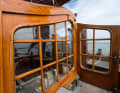 Large lattice windows are installed in the superstructure bulkhead and in the companionway door