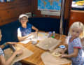 Rolling out dough and cutting out biscuits - most children love baking, and the girls on the "Lady Blue" do too