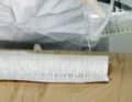 Now soak the glass scrim. Apply a generous amount of resin. It will soak into the material almost by itself, but should be ...