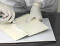 The repair area is sanded over a large area with 80-grit paper until the surface is evenly matt
