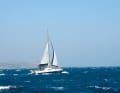A Broadblue cat high on the wind. The sails are reduced in line with the increasing wind