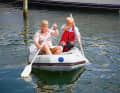 If the dinghy is too small for this, the only option is to paddle sitting on the tube