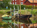 Small classic boats are moored at the jetty in Pataholm