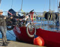 With the help of the genoa halyard, the motorbikes, each weighing around 70 kilograms, are loaded through the hatch into the forward cabin