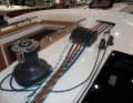 Arranged. Halyards and trim lines are attached to the "pianos" on the companionway to the