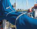 Mainsail: Tie the lazy-jacks forwards to the mast and additionally secure the sail cover. Wrap a long line around it several times. This reduces the area exposed to the wind and additionally secures the tarpaulin against chilling. If the mainsail is not attached too elaborately, with mast sliders or continuous battens, it can also be cut off. For furling mainsails, additionally secure the clew with one end to the mast