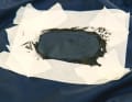 4. the patch is pressed onto the adhesive. Press on with a spatula to spread the sealant evenly