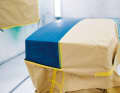 1. primed. The paper catches the spray mist, a film underneath prevents the paint from penetrating