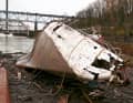 After the salvage operation, the hull of the once proud twelve-person vessel lies on land like a beached whale