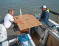 Bulky. The cockpit table comes as a complete element. The plate simply rests on the cockpit floor when sailing