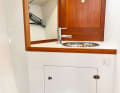 Arcona 385 The washbasin is very small. But there is an open oilskin locker