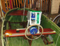Above the steering wheel is a bulky box with a voltage converter. The skipper inserts a tablet for navigation into the box